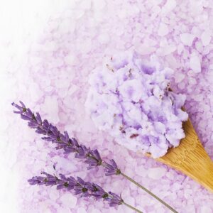 Homemade lavender body scrub in wooden spoon