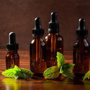 fresh mint Peppermint herb leaves essential oil in dropper bottles